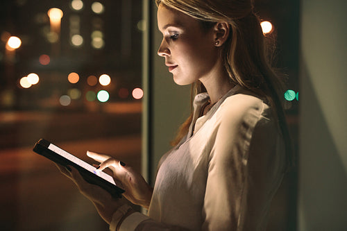 Beautiful female working late night in office