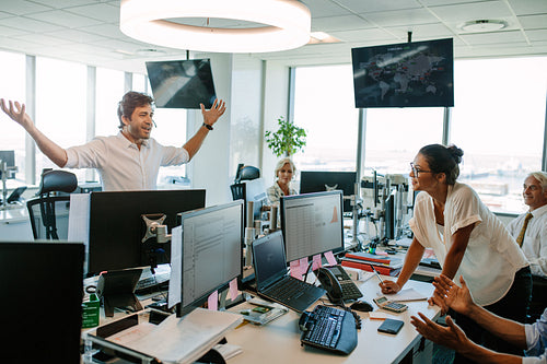 Young man showing excitement after closing a deal in office