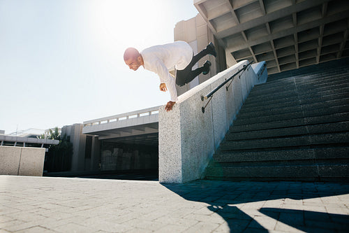 Man practicing parkour in urban space