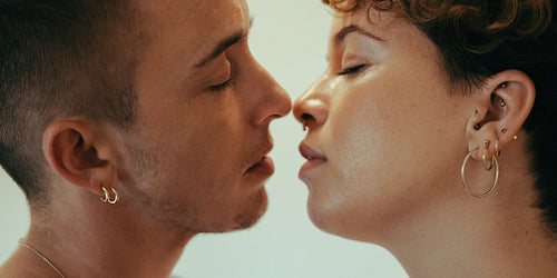 Closeup of an affectionate queer couple going in for a kiss