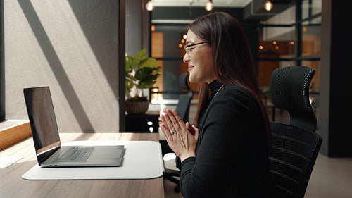 Female remote worker having a discussion with her team in an online meeting
