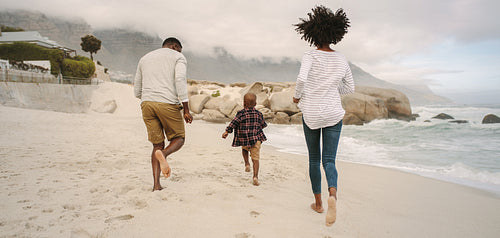 Family running on beach