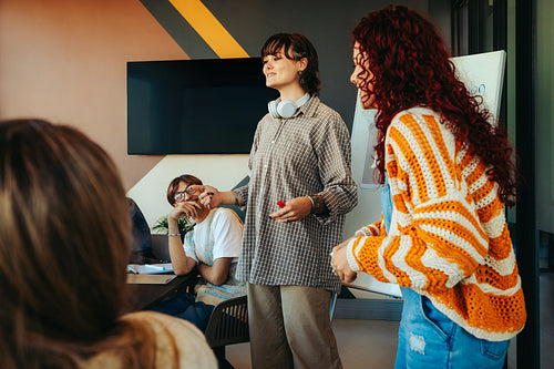 Generation Z group task in a modern office setting with young professionals giving a presentation to their team members