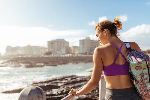 Relaxed woman at seaside after her workout
