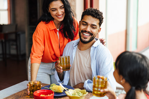 Family enjoying a casual outdoor meal together in a cheerful setting