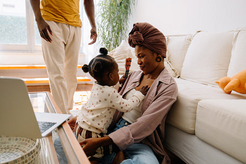 Family moment at home with child and ukulele