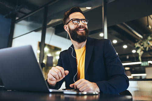 Contemplative businessman smiling cheerfully