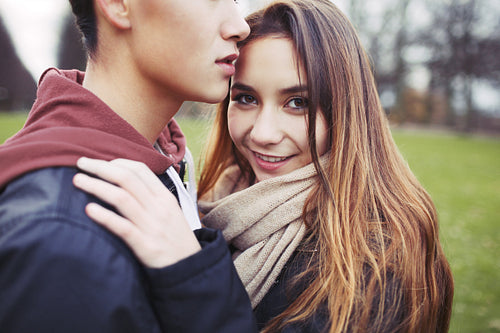 Beautiful teenage girl with her boyfriend in park