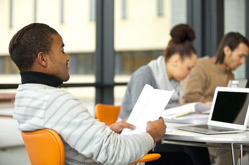 Young man studying hard for exams