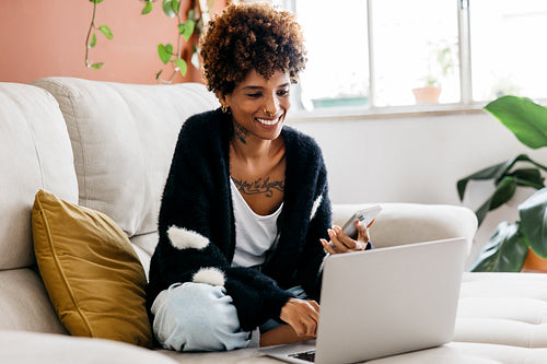 Casually working from home in a home office setup with a comfortable couch and laptop