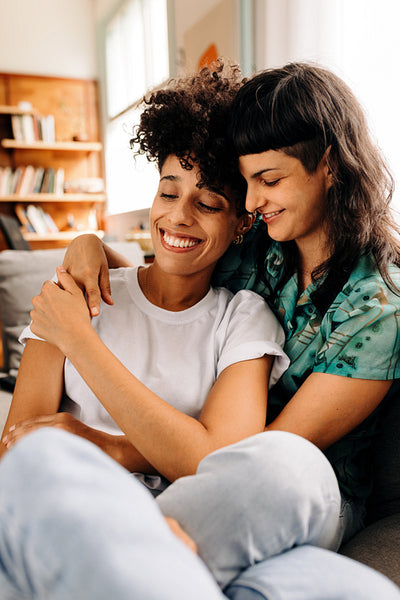 Young lesbian couple cuddling each other