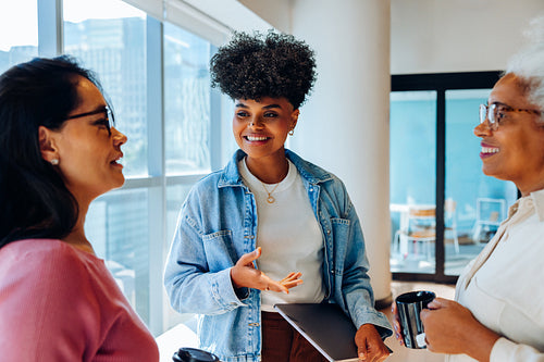 Business conversation: Young Black woman shares updates with coworkers