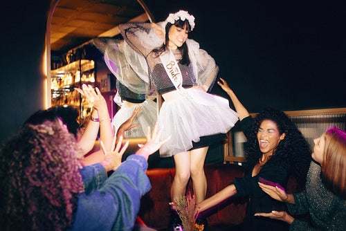 Bride-to-be celebrating with friends at a joyful and lively party event