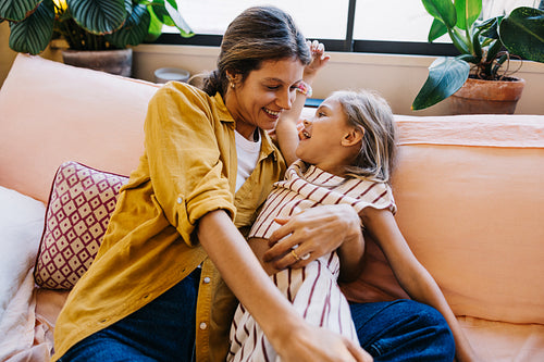 Family moment on cozy sofa with mother and daughter