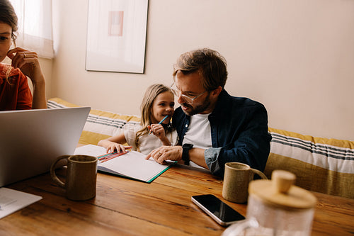 Family at home studying together with child