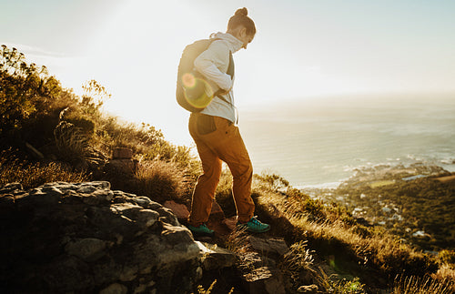 Watching her steps while going down the mountain trail