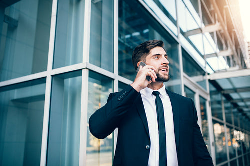 Business man using mobile phone at airport