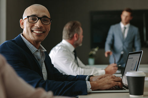 Smiling businessman during a meeting in conference room
