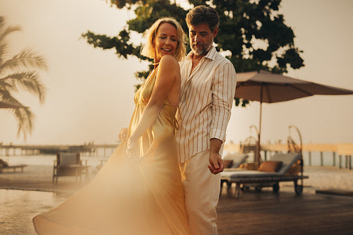 Couple flirting and enjoying a holiday moment poolside