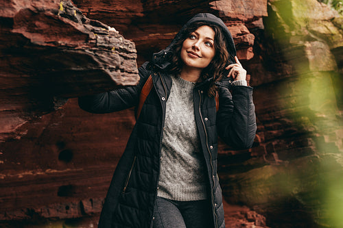 Female in winter wear on mountain looking at view