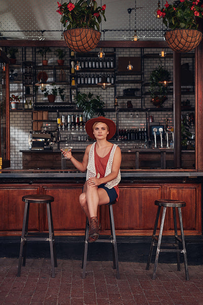 Beautiful young woman sitting at a cafe with a drink