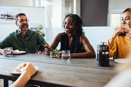 Architectural team enjoying a casual lunch meeting in a modern workspace atmosphere