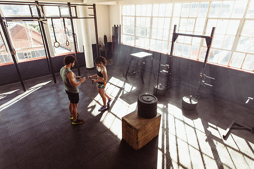 Fit young couple at cross training gym