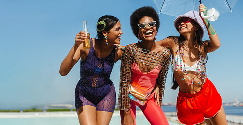 Friends celebrate on a sunny beach carnival today