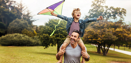 Parenthood: Father and son being playful at the park
