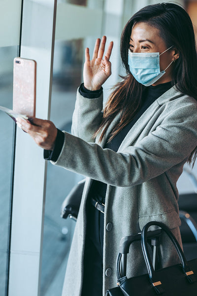 Woman making a video call at airport lounge