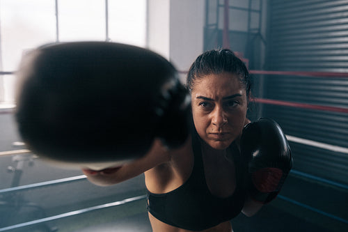 Female boxer training inside a boxing ring