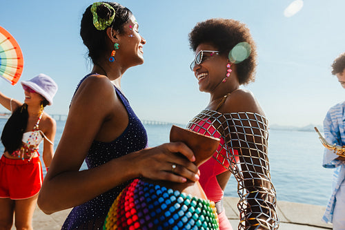 People celebrating carnival by the sea