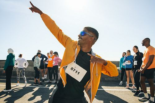 Male athlete striking a pose at outdoor running event