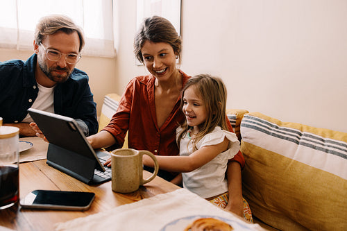 Family moments as parents and child use tablet