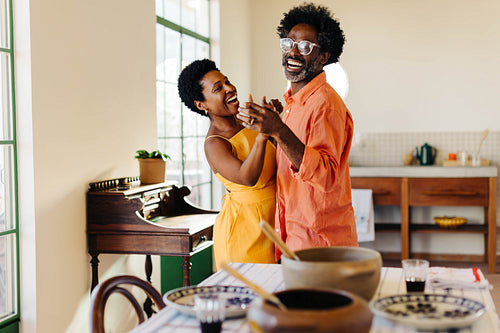 Cheerful Brazilian family enjoying traditional feijoada dinner