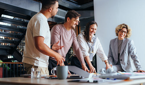 Successful business team working on a project in an advertising agency, they discuss different ideas during a meeting
