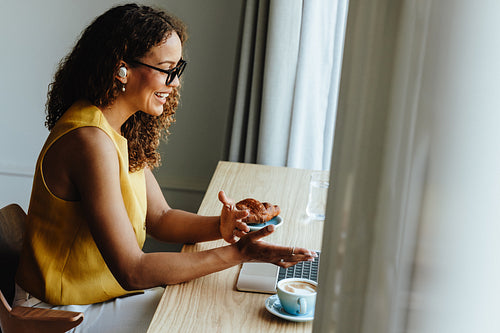 Freelance business woman gestures during video call at home office