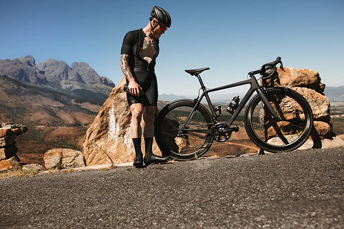 Professional cyclist checking his bike