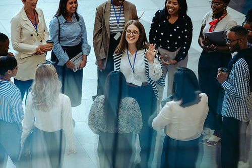 Professional team engaged in a morning business meeting in a modern office lobby