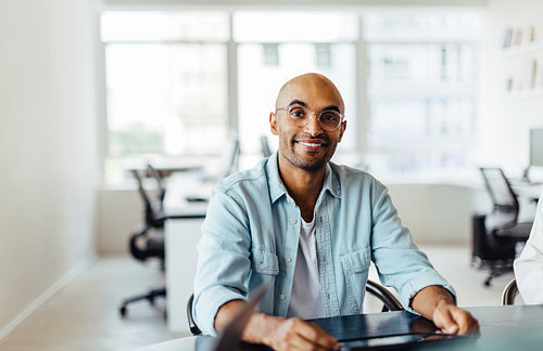 Male designer sitting at a table in an office