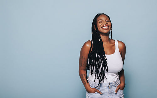 Stylish woman smiling while standing in a studio
