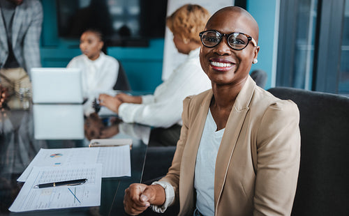 Mature business woman attending a successful corporate meeting with professionals in a boardroom