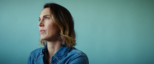 Thoughtful business professional contemplates in a medium wide shot