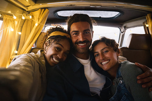 Friends take a selfie in a cozy van on a joyful road trip