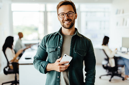 Portrait of a male professional standing in an office
