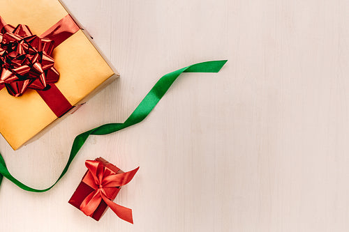 Gift boxes with ribbon on wooden background
