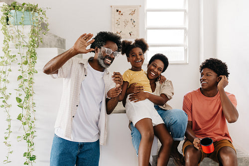 Mature man having a fun time with his family at home