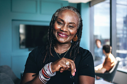 Happy business woman looking at the camera in an office meeting