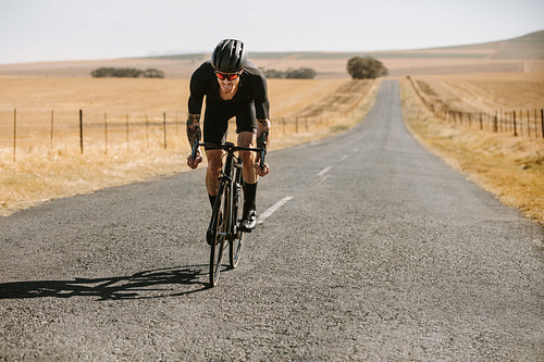 Racer riding hard on a bicycle