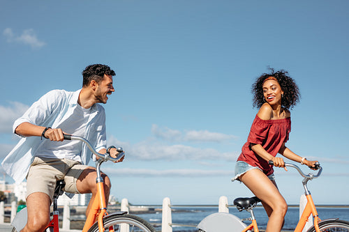Cheerful couple riding bicycles on a sunny day